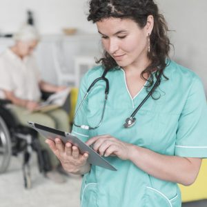 portrait-female-nurse-with-stethoscope-around-her-neck-using-digital-tablet